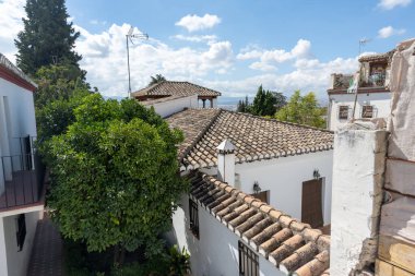 Aerial view of the city of Granada, Spain, showcasing the historic center, the Cathedral, the Alhambra, and characteristic Andalusian neighborhoods. Perfect image for urban landscape, tourism, culture, and architecture concepts.