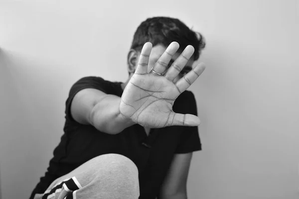 stop hand of teenager, sign of discrimination or anti violence symbol. Stop abusing violence. Young child bondage, violence, terrified, fearful child, Human Rights Day concept. black and white image.