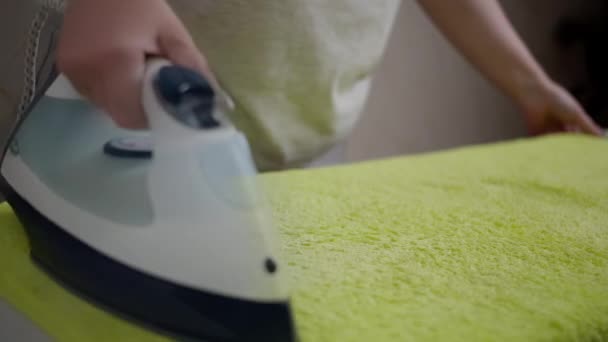 Woman housewife ironing soft terry towel, rack focus, close up — Stock Footage Woman housewife ironing soft terry towel, rack focus, close up Royalty Free Stock Footage