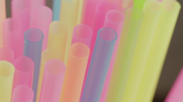 Tubes à cocktail multicolores en plastique, gros plan, mouvement de la caméra, mise au point rack — Video