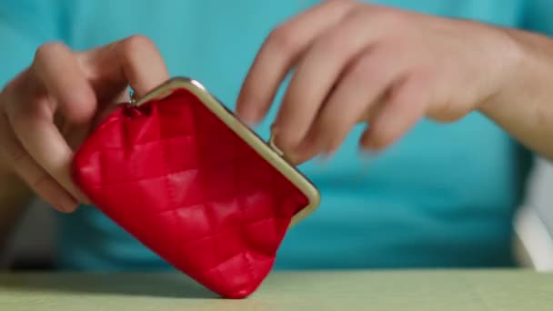 Mężczyzna wylewający monety na stół z czerwonego portfela, zbliżenie — Wideo stockowe