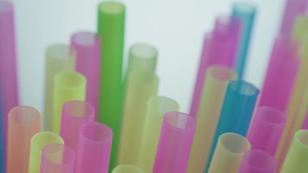 Cocktail Tubos plásticos multicoloridos em um fundo escuro, movimento da câmera — Vídeo de Stock