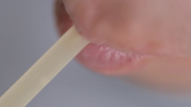 A man quenches his thirst and drinks from a plastic tube, top view, close-up — Stock Video