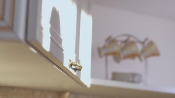 Female hand takes a plate from the kitchen cabinet, close up, camera tracking — Stock Video