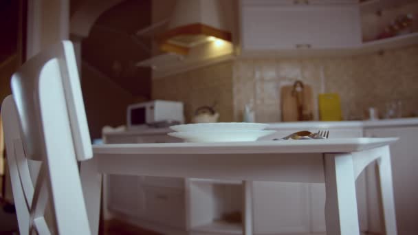 White table and chair against the background of the kitchen, a set table for dinner — 비디오