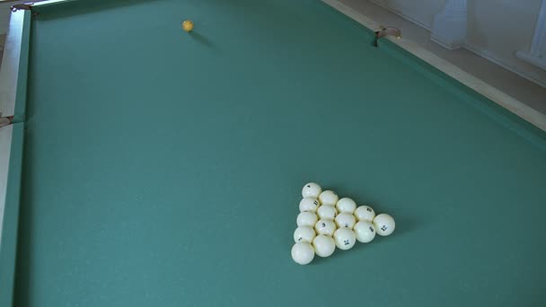 Player plays billiards breaks pyramid of balls — Stock Video