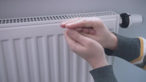 De mannelijke hand regelt de verwarming van de batterij met een controller. Het concept van het besparen van warmte — Stockvideo