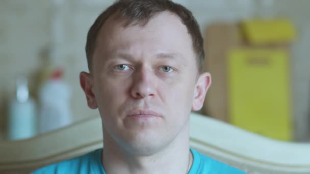 Portrait of a young man with gray eyes looking at the camera, selective focus — Stock Video