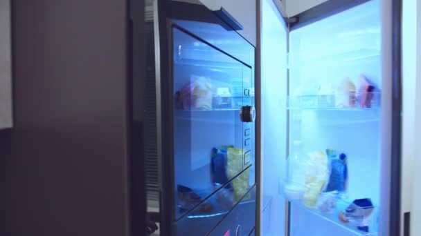 Man takes out a plate of food and puts it in the microwave for quick heating — Stock Video