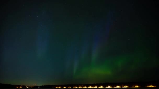 在北冰洋的一个冰封的湖面上 在星空下跳舞的是绿色和粉色的北极光 — 图库视频影像