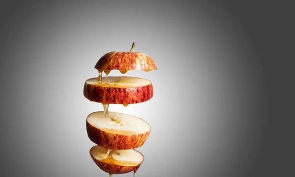 Fresh Sliced Red Apple Honey Dripping Flying Food Levitation Reflection — Stock Photo, Image