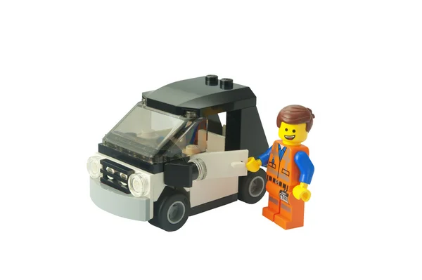 Эммет и его машина Lego Minifigure — стоковое фото