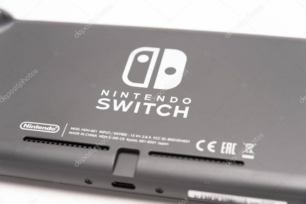 Fuji City, Shizuoka Ken, Japan - May 23, 2021: Nintendo Switch Lite Console Gray. Isolated on white background. Back view. Close-up.