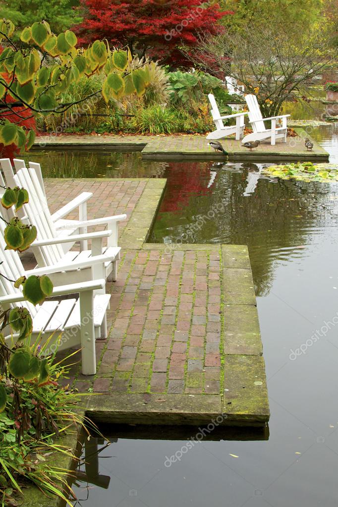 depositphotos_63555831 stock photo garden chairs at the pond