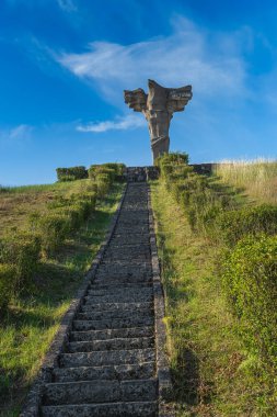 Cedynia, Poland, June 2019 An eagle statue on the top of Czcibor Mountain unveiled in 1972 for a thousand anniversary of Battle of Cedynia where Poland defeated forces of Germany clipart