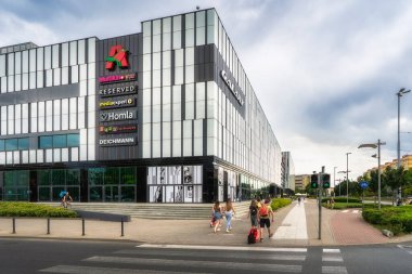 Szczecin, Poland, 5 Aug 2021 A modern shopping mall, Galaxy, facade showcases appealing signage, bustling pedestrians, and a lively urban environment that captures the essence of city life