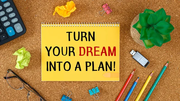 Turn your Dream into a Plan. Inspirational motivating quote on notebook
