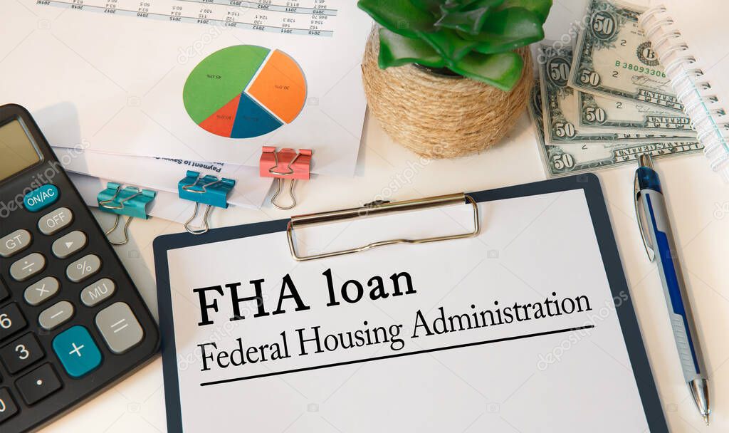Office desk with documents, concept image for blog headline or header image. Federal Housing Administration FHA loan inscription on paper.