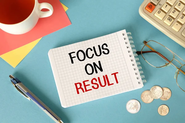 Focus on results is written on a notepad, on an office desk with office accessories.