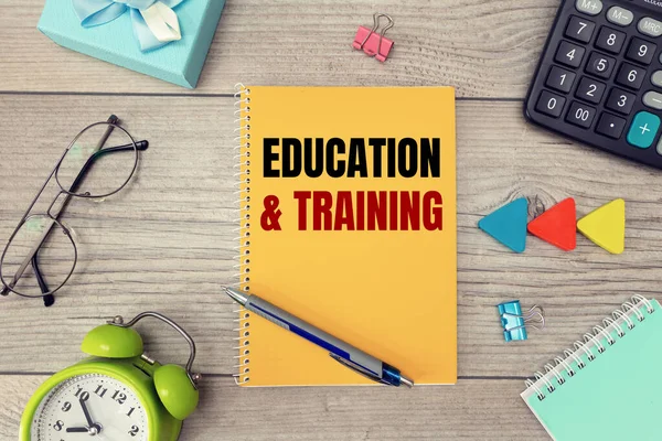 EDUCATION and TRAINING is written on a notepad, on an office desk with office accessories.