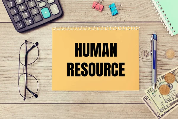 Human resource is written on a notepad on an office desk with office accessories.
