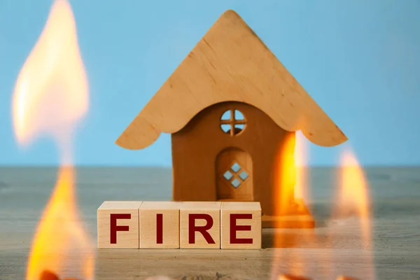 Insurance concept. Natural disaster risk insurance, real estate insurance. Wooden cubes with word FIRE