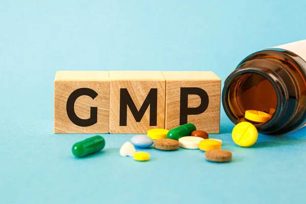 GMP Good Manufacturing Practice - inscription on wooden cubes