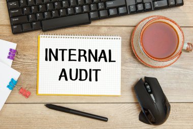INTERNAL AUDIT bir ofis masasının üzerindeki bir not defterine yazılır..