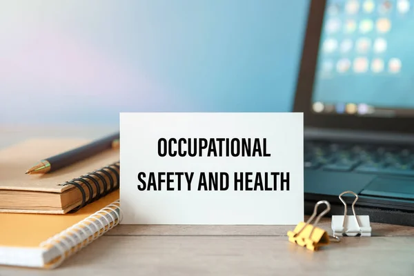 Occupational Safety and Health - an inscription on a card on the background of a computer keyboard