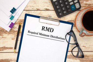 Bir tablo, hesap makinesi ve gözlük üzerinde Gerekli Minimum Dağıtım RMD içeren kağıt