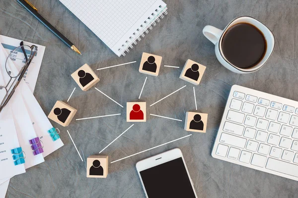 Organization structure, team building, recruitment, management and human resources concepts. Person icons on wooden cubes linked to each other.