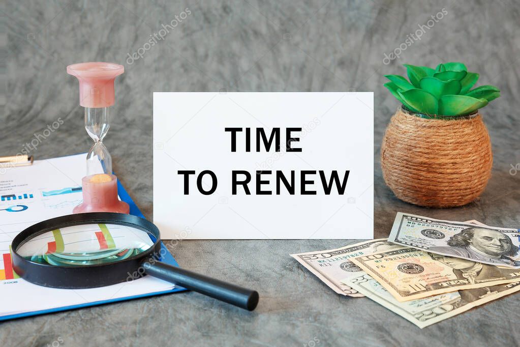 Time to renew is written in a document on the office desk with office accessories, money, diagram and magnifier