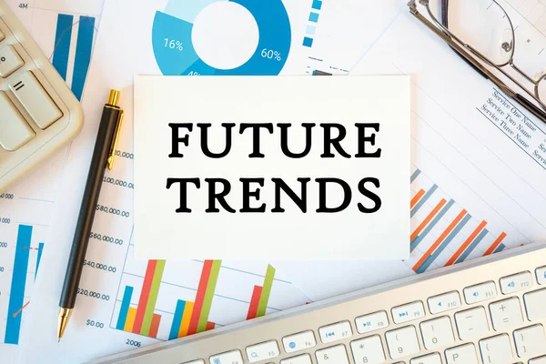 FUTURE TRENDS is written in a document on the office desk with office accessories, diagram and keyboard