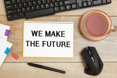 Ofis masası ve not defteri. Geleceği, klavyeyi ve bir fincan çayı oluşturuyoruz.