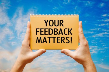 Elinde bir kart tutan adam mavi bir gökyüzünün arka planında 