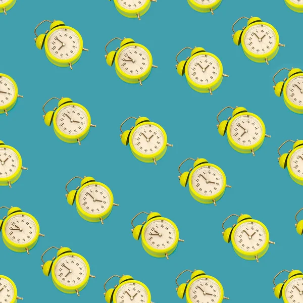 Seamless texture of alarm clocks in classic style isolated on light blue background. Smile time concept