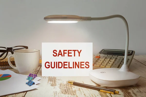 Office desk with a lamp that illuminates the inscription Safety Guidelines