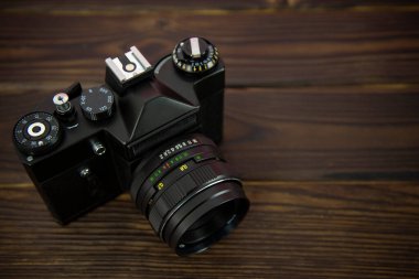 Ahşap bir yüzeyde eski bir fotoğraf makinesi.