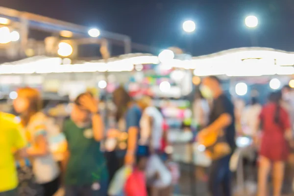 Abstract of blurred people walking in shopping centre at twiligh — Stock Photo, Image