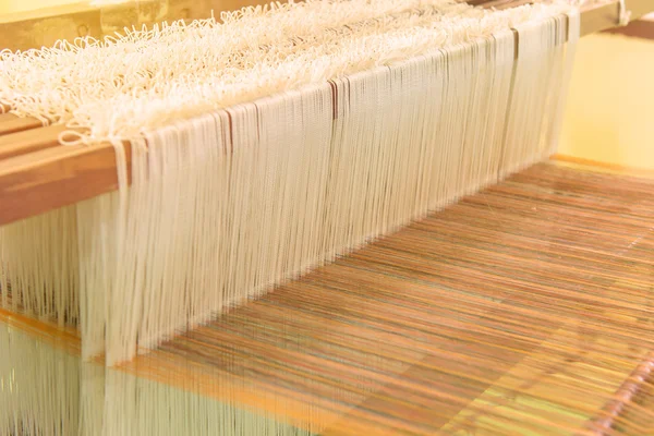 Weaving loom and shuttle on the warp — Stock Photo, Image