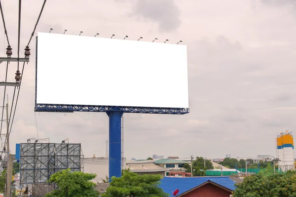 Large blank billboard on road with city view background — Stock Photo, Image