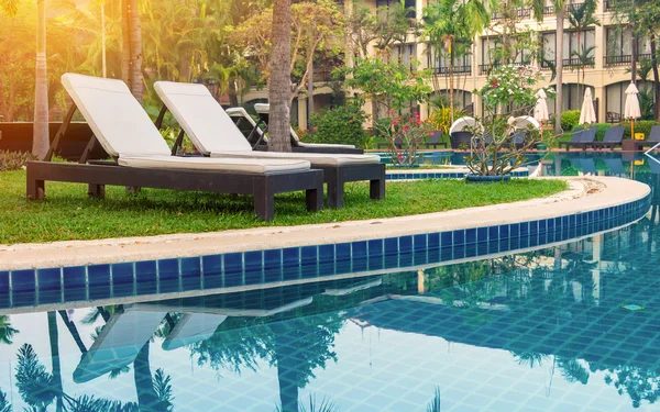 Pool bed near swimming pool in tropical resort — Stock Photo, Image