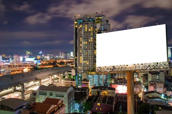 Blank billboard for advertisement in city downtown at night — Stock Photo, Image