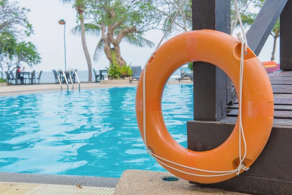 Red lifebuoy near a public swimming pool — Stock Photo, Image