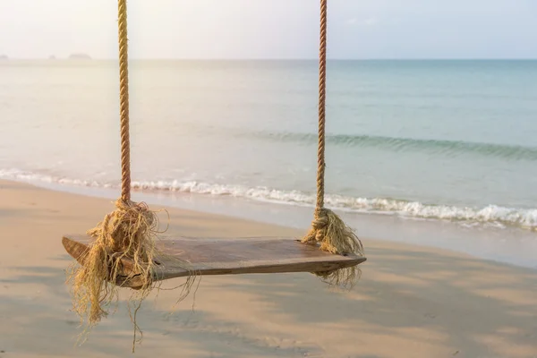 Rope swing under tree on ocean beach — Stock Photo, Image