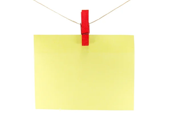 Yellow sheet of paper for notes and paperclip — Stock Photo, Image