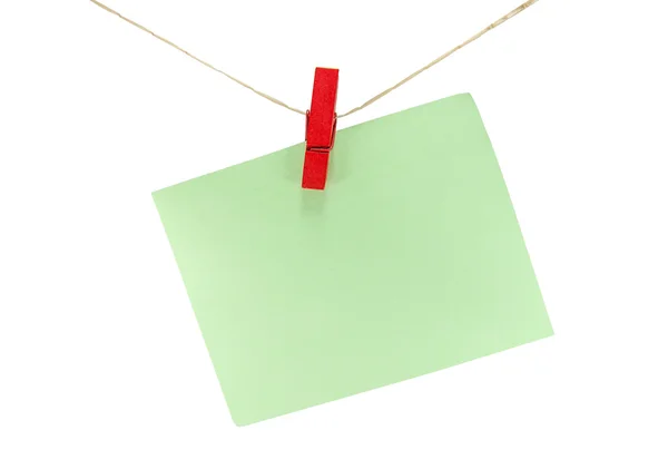 Green sheet of paper for notes and paperclip isolate on white — Stock Photo, Image