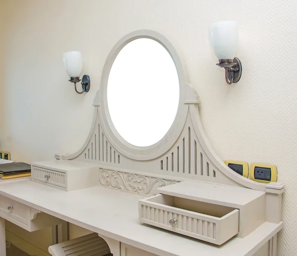 Wooden carved dressing table with blank frame in room — Stock Photo, Image