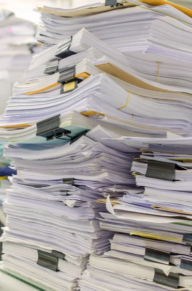 Pile of documents on desk stack up high waiting to be managed — Stock Photo, Image