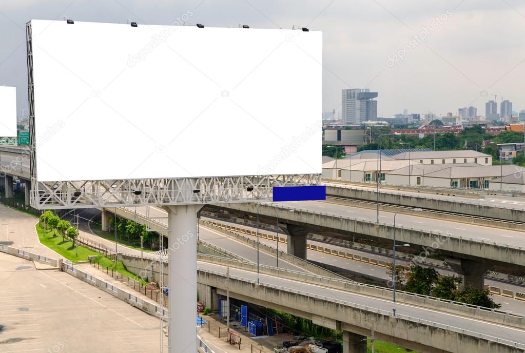 large blank billboard on road with city view background